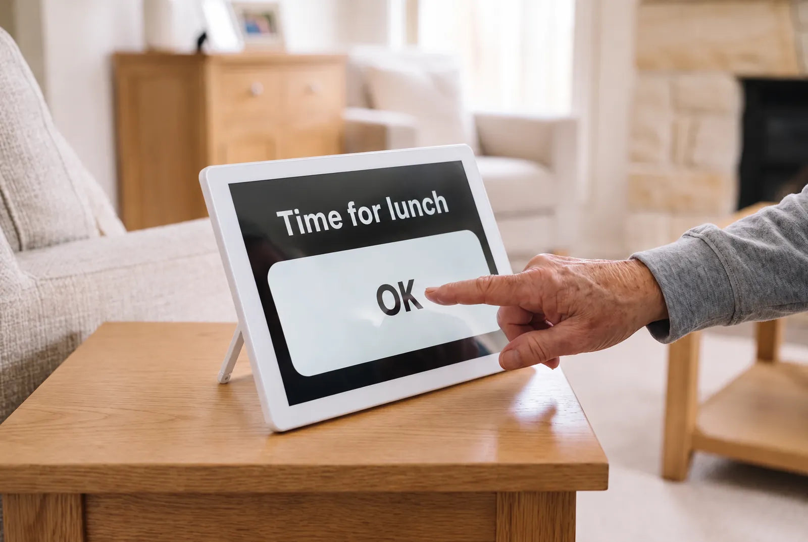 A hand tapping the large OK button on a reminder